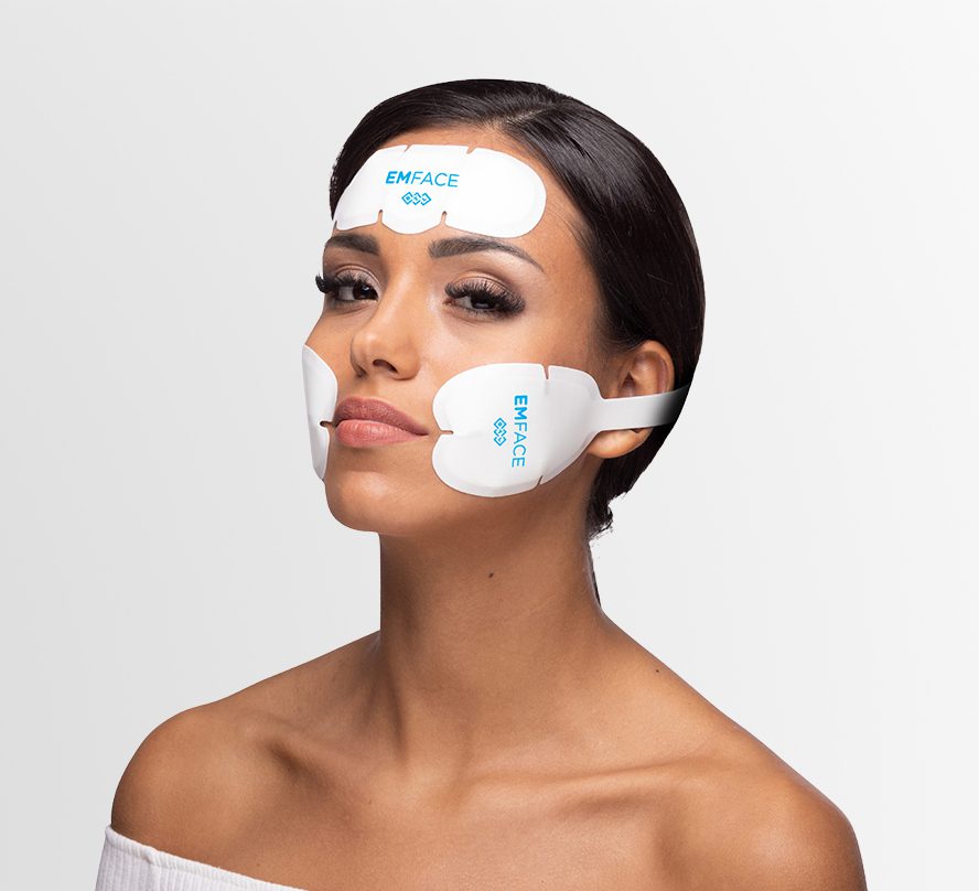 A beautiful woman shows the Emface device being used to help lift and tone the face.