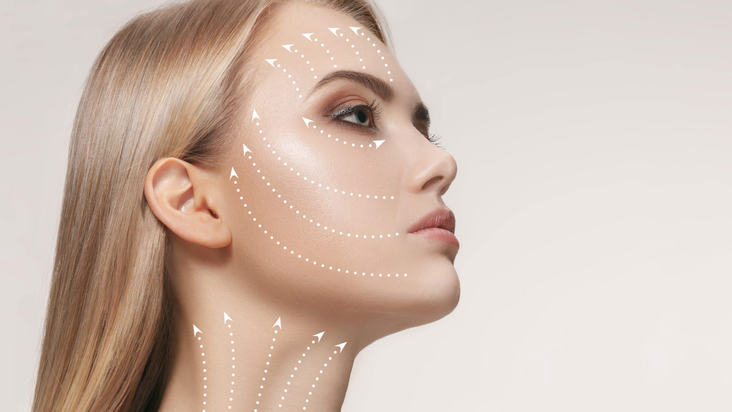 A beautiful blonde woman shows the benefits of a facial rejuvenating facelift at Optimum Human in Albuquerque, NM.